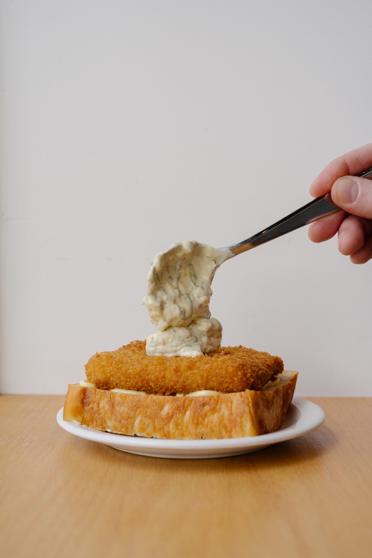 A spoonful of shiso remoulade over a shrimp cutlet